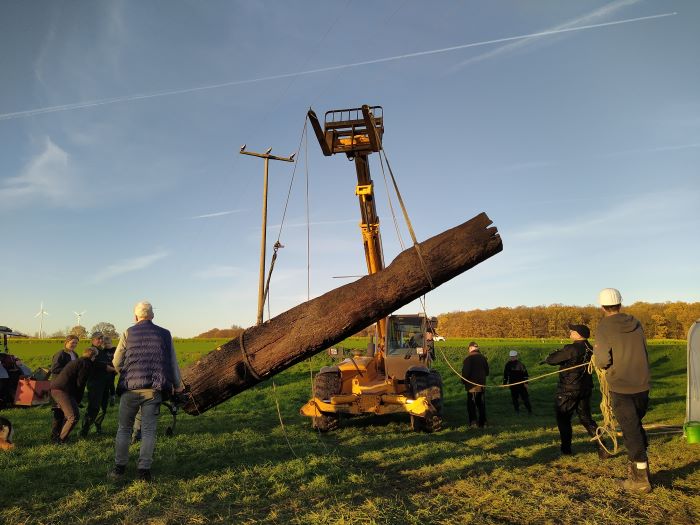Bergung eines mittelalterlichen Bootswrack in Lippe. Bergung eines mittelalterlichen Bootswracks durch einen Kran. Zwei Personen stehen links und rechts am Rande.